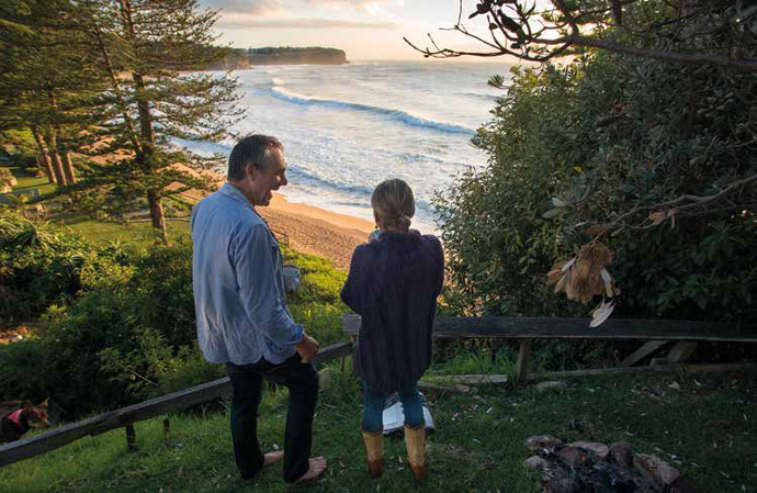Dirk Hofman and Godelieve Hofman-Verkuyl in the backyard, Bilgola Headland in the background. Photo: Bruce Usher